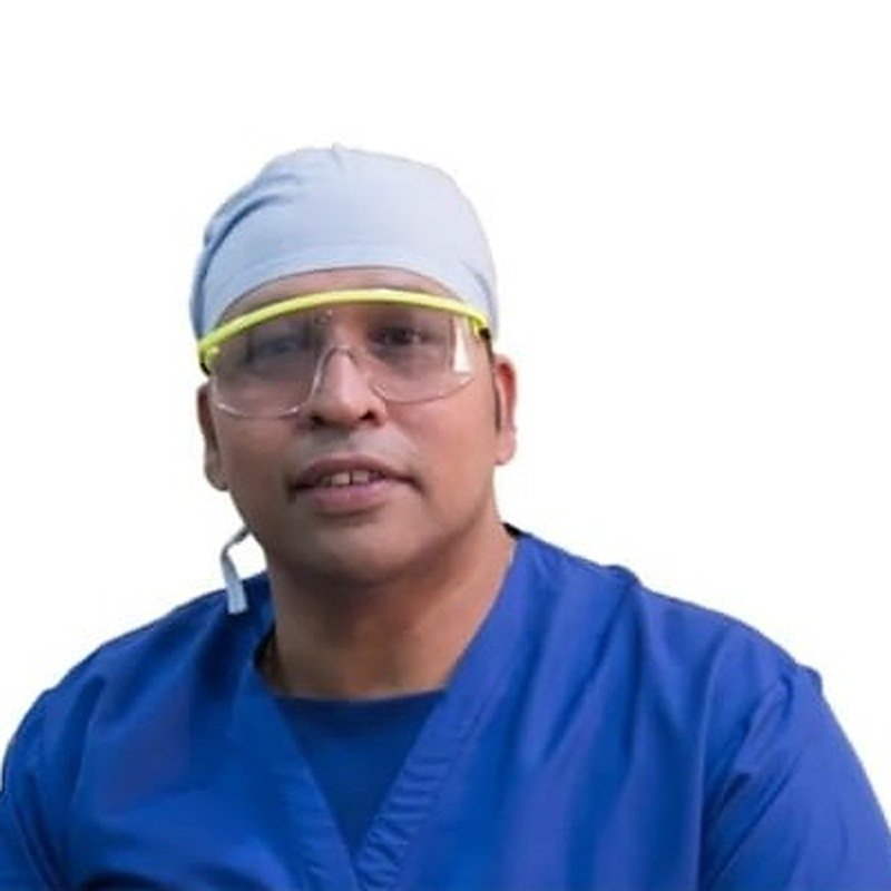 Dr. Amit R. Gandhi in surgical scrubs — M.S. Oncosurgeon and HIPEC surgeon, Mumbai